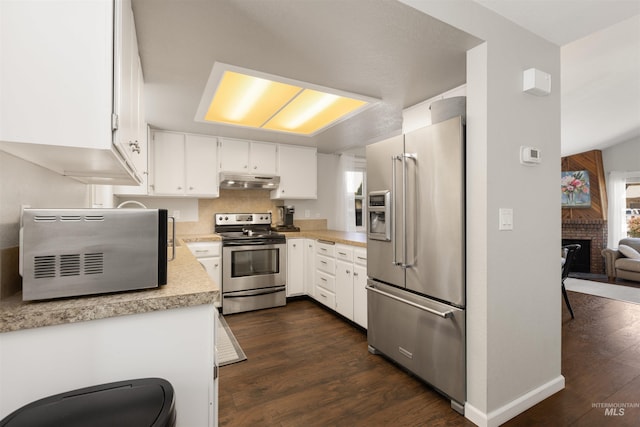 6835 W Freemont St, Boise, ID 83704 - kitchen featuring stainless steel appliances, under cabinet range hood, dark wood-style flooring, light countertops, and white cabinets