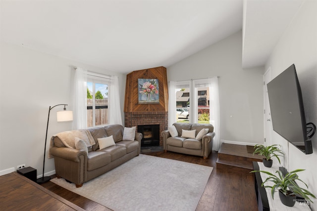 6835 W Freemont St, Boise, ID 83704 - living room with wood finished floors, vaulted ceiling, and a brick fireplace