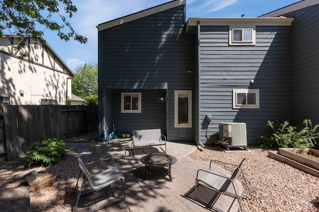 6835 W Freemont St, Boise, ID 83704 - rear view of house featuring an outdoor fire pit, a patio area, and a vegetable garden
