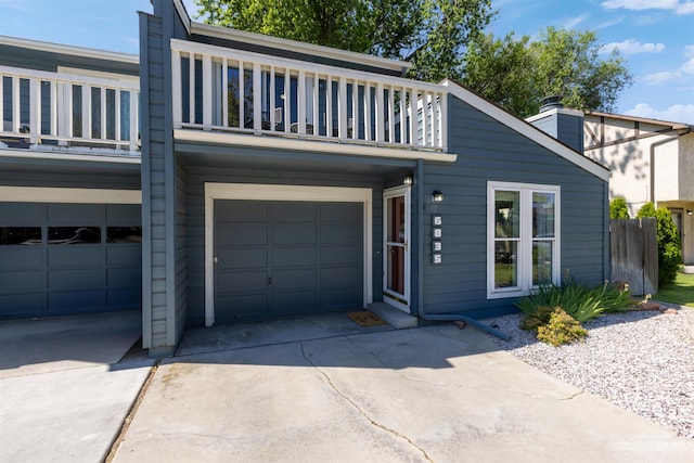 6835 W Freemont St, Boise, ID 83704 - view of front of house with a balcony, an attached garage, and concrete driveway