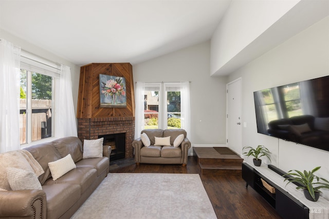 6835 W Freemont St, Boise, ID 83704 - living area featuring vaulted ceiling, healthy amount of natural light, wood finished floors, and a fireplace