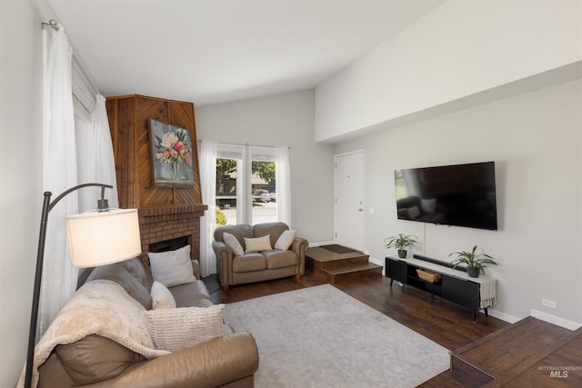 6835 W Freemont St, Boise, ID 83704 - living area with vaulted ceiling, dark wood-style floors, and a fireplace