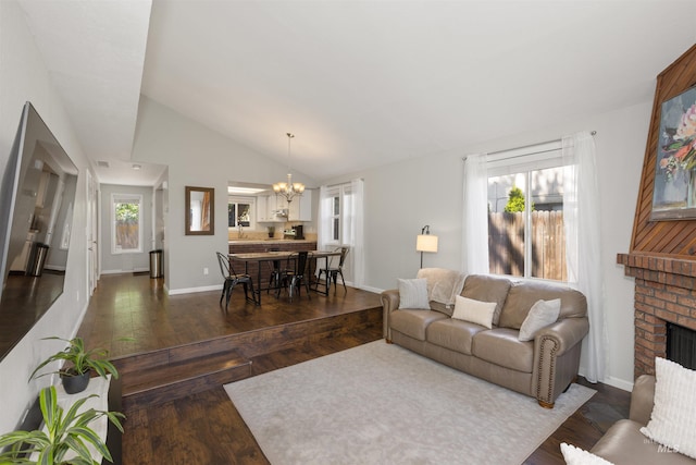 6835 W Freemont St, Boise, ID 83704 - living area with a chandelier, dark wood finished floors, lofted ceiling, and a brick fireplace