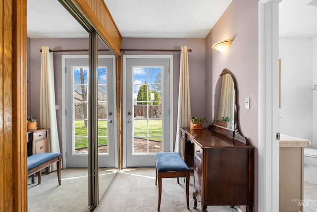 doorway featuring light carpet