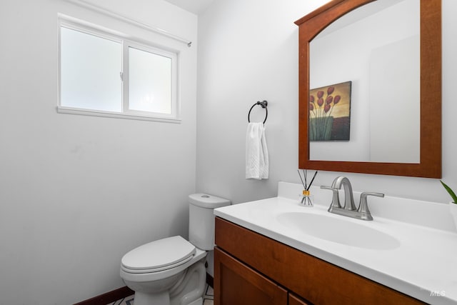 bathroom with toilet and vanity