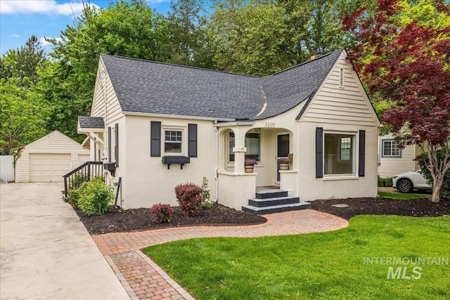 3205 W Crescent Rim Dr, Boise, ID 83706 - view of front of property featuring a shingled roof, an outbuilding, a detached garage, and a front yard