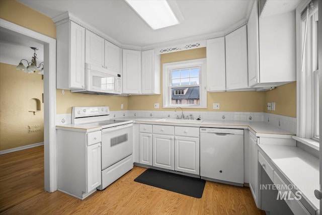 3205 W Crescent Rim Dr, Boise, ID 83706 - kitchen with white appliances, a sink, white cabinetry, light wood-style flooring, and a chandelier
