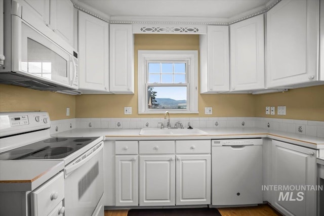3205 W Crescent Rim Dr, Boise, ID 83706 - kitchen featuring white appliances, a sink, white cabinets, and light countertops