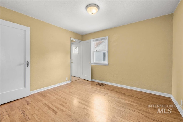 3205 W Crescent Rim Dr, Boise, ID 83706 - unfurnished bedroom featuring wood finished floors and baseboards