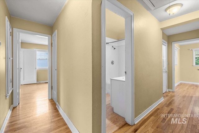 3205 W Crescent Rim Dr, Boise, ID 83706 - hall featuring light wood-style flooring, baseboards, and attic access