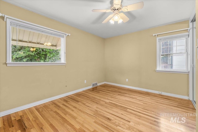 3205 W Crescent Rim Dr, Boise, ID 83706 - unfurnished room with baseboards, wood finished floors, and ceiling fan
