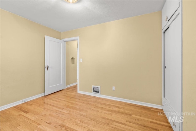 3205 W Crescent Rim Dr, Boise, ID 83706 - unfurnished bedroom with baseboards, light wood-style floors, and a closet