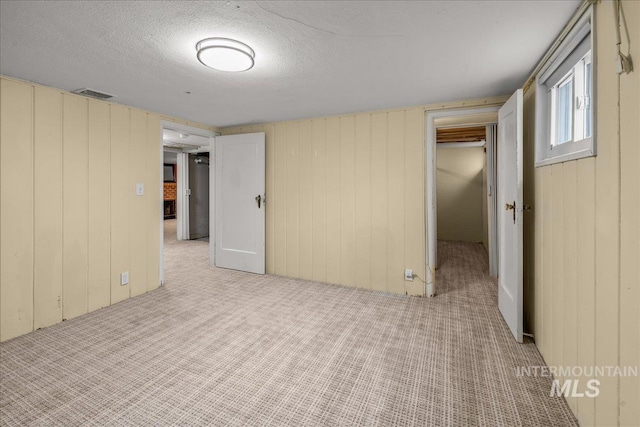 3205 W Crescent Rim Dr, Boise, ID 83706 - carpeted empty room with wood walls and a textured ceiling