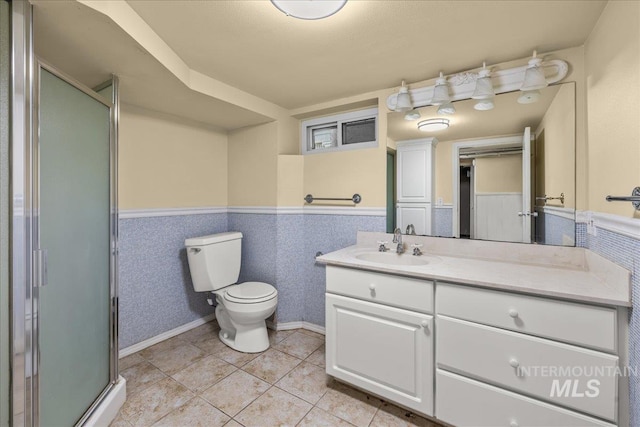 3205 W Crescent Rim Dr, Boise, ID 83706 - bathroom with a wainscoted wall, a stall shower, vanity, toilet, and tile patterned flooring