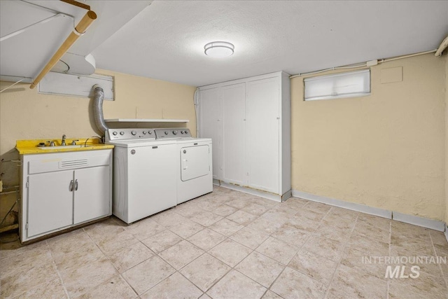 3205 W Crescent Rim Dr, Boise, ID 83706 - washroom featuring independent washer and dryer, cabinet space, and a textured ceiling