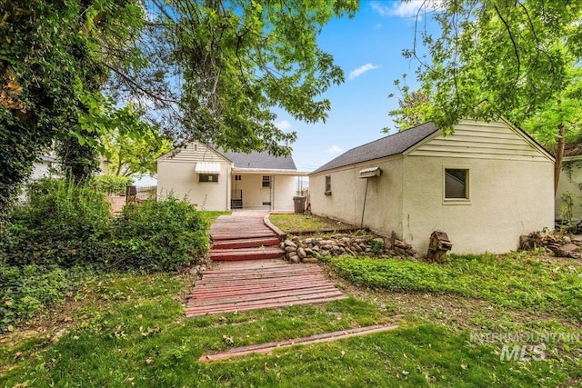 3205 W Crescent Rim Dr, Boise, ID 83706 - rear view of house featuring stucco siding
