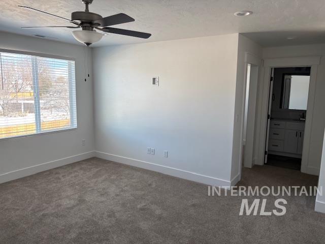 carpeted empty room with ceiling fan