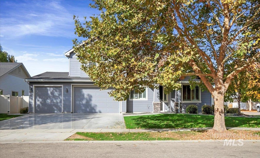 obstructed view of property with a front yard and a garage