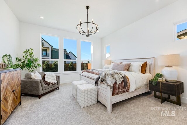 carpeted bedroom featuring multiple windows and a chandelier