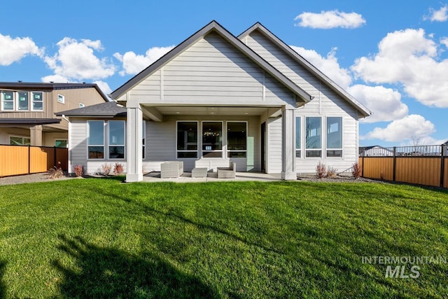 back of property featuring a patio area and a yard