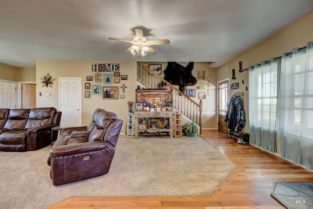 28284 Tudie Ln, Parma, ID 83660 - living room featuring a ceiling fan, wood finished floors, and stairway