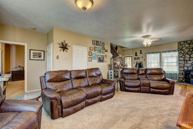 28284 Tudie Ln, Parma, ID 83660 - carpeted living area with a textured ceiling, stairs, and ceiling fan