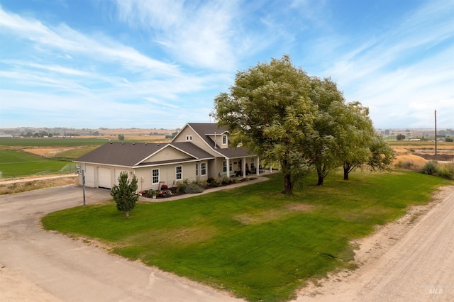 28284 Tudie Ln, Parma, ID 83660 - view of front of property with an attached garage, a rural view, a front yard, and concrete driveway