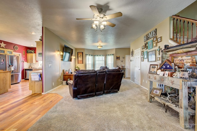 28284 Tudie Ln, Parma, ID 83660 - living area with a textured ceiling, light carpet, baseboards, and ceiling fan