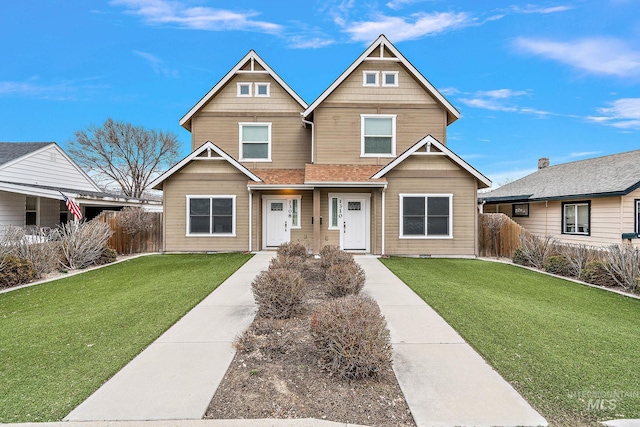 craftsman-style home featuring a front yard and fence