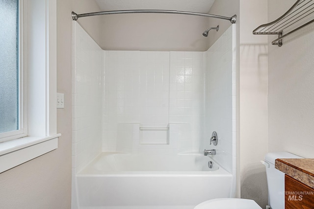 bathroom featuring bathtub / shower combination, vanity, and toilet