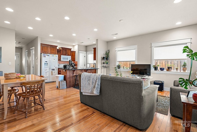 living room featuring recessed lighting and light wood finished floors