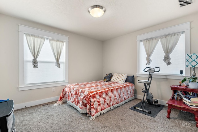 bedroom with carpet flooring, visible vents, and baseboards