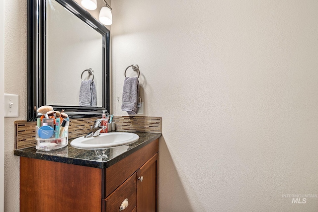 bathroom with decorative backsplash and vanity