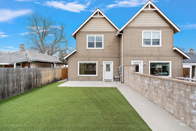 back of property featuring a patio, a lawn, and a fenced backyard