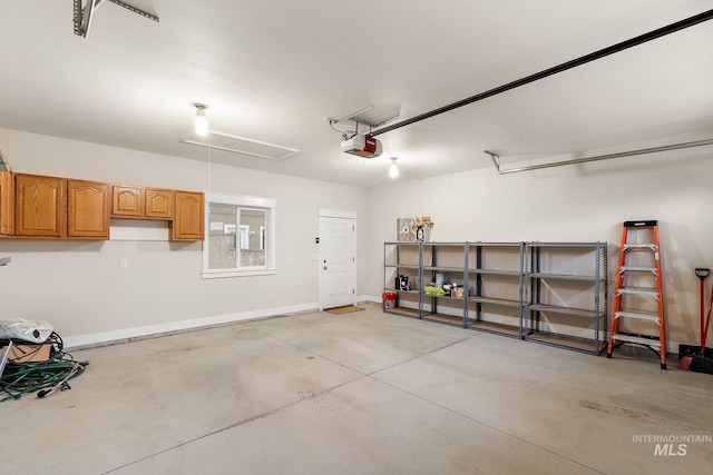 garage with baseboards and a garage door opener