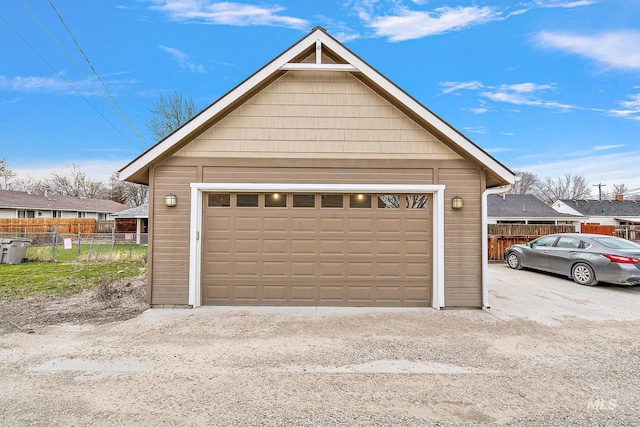 detached garage featuring fence