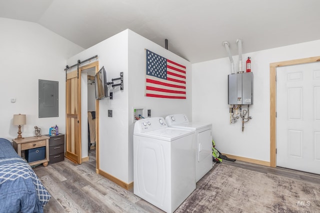 205 N Fouch, Parma, ID 83660 - laundry room featuring electric panel, washer and dryer, a barn door, light wood-style floors, and water heater