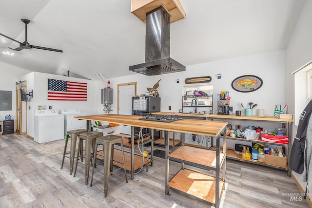 205 N Fouch, Parma, ID 83660 - kitchen featuring island range hood, washing machine and dryer, lofted ceiling, ceiling fan, and electric panel