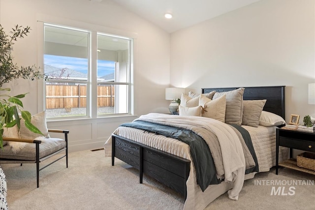 bedroom with recessed lighting, lofted ceiling, and carpet