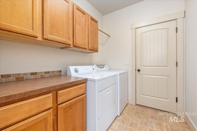 2895 E Shadowwolf Dr, Eagle, ID 83616 - laundry room featuring washer and clothes dryer, cabinet space, and stone finish flooring