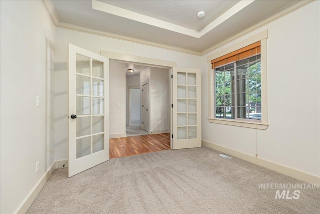 2895 E Shadowwolf Dr, Eagle, ID 83616 - carpeted spare room featuring french doors, crown molding, a smoke detector, and a raised ceiling