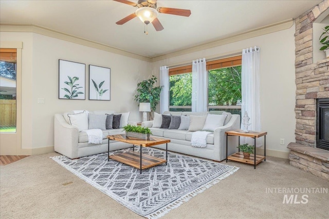2895 E Shadowwolf Dr, Eagle, ID 83616 - carpeted living room featuring a stone fireplace, ceiling fan, and crown molding