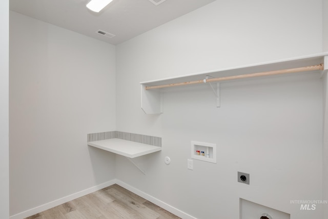 laundry area featuring washer hookup, light wood-style flooring, electric dryer hookup, laundry area, and baseboards