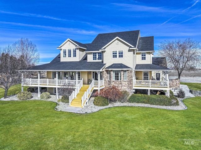 930 W Wanda Ln, Heyburn, ID 83336 - view of front of house with a porch, a front yard, and roof with shingles