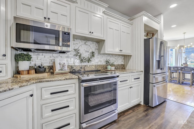 930 W Wanda Ln, Heyburn, ID 83336 - kitchen featuring appliances with stainless steel finishes, dark wood finished floors, backsplash, white cabinetry, and recessed lighting