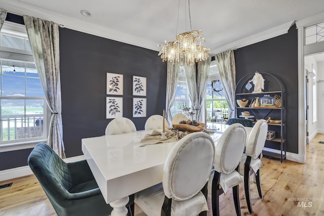 930 W Wanda Ln, Heyburn, ID 83336 - dining space with hardwood / wood-style floors, a chandelier, baseboards, crown molding, and healthy amount of natural light