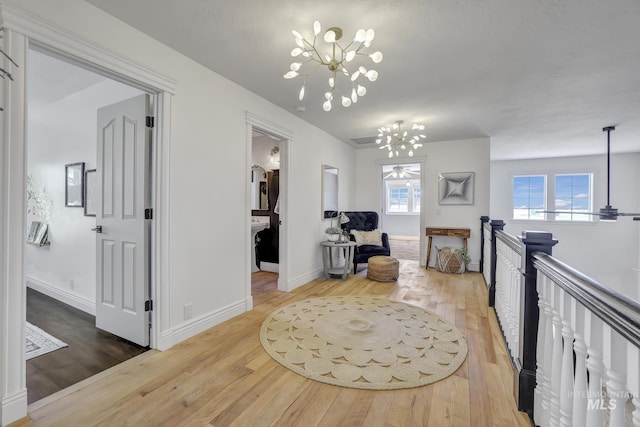 930 W Wanda Ln, Heyburn, ID 83336 - hallway with a chandelier, hardwood / wood-style floors, and baseboards