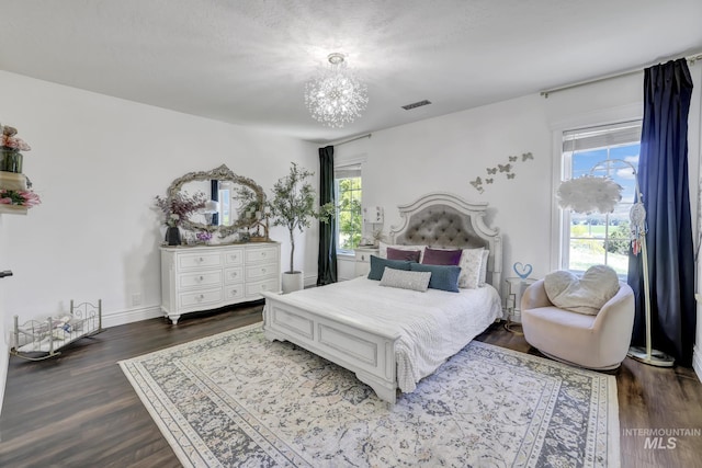 930 W Wanda Ln, Heyburn, ID 83336 - bedroom featuring multiple windows and dark wood-style floors