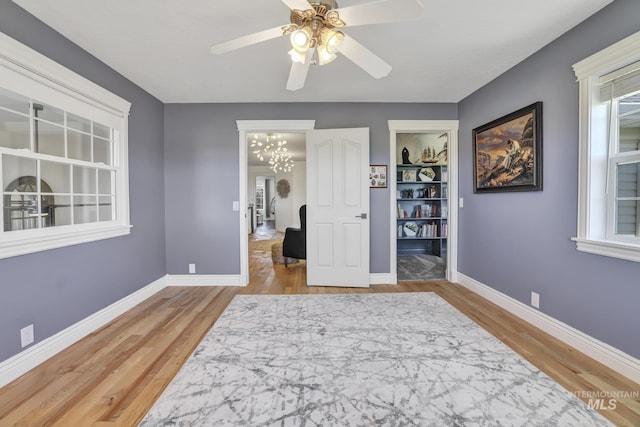 930 W Wanda Ln, Heyburn, ID 83336 - bedroom with baseboards, wood finished floors, a chandelier, and ceiling fan