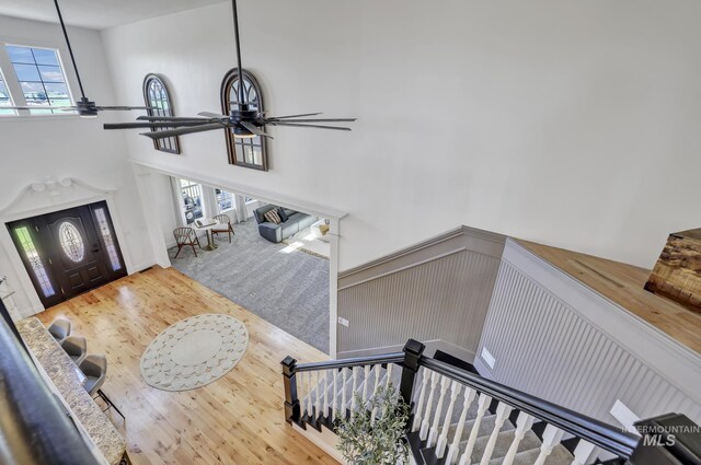 930 W Wanda Ln, Heyburn, ID 83336 - foyer featuring ceiling fan, wood finished floors, a towering ceiling, and a wainscoted wall